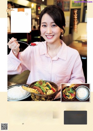 A woman sitting at a table with a plate of food.