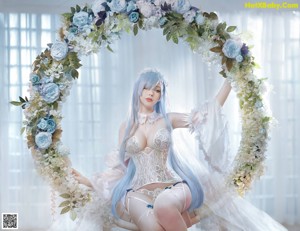 A woman in a white lingerie posing for a picture.