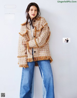 A woman in a yellow skirt and a blue jacket.