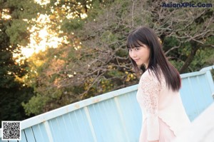 A young woman with long black hair and a red jacket.