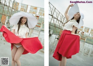 A woman in a white shirt and red skirt sitting on the floor.