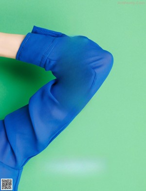 A woman in a blue shirt is posing for a magazine.