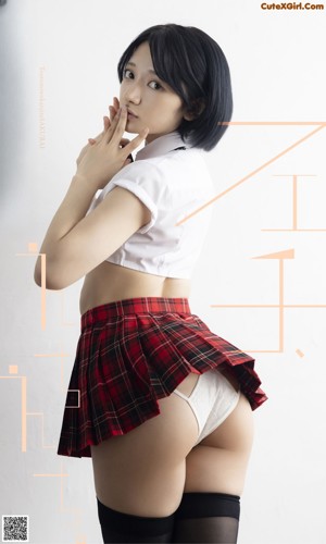 A woman in a school uniform is posing for the camera.