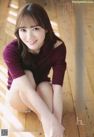 A woman sitting on top of a wooden table.