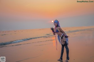 A woman with long purple hair is posing for a picture.
