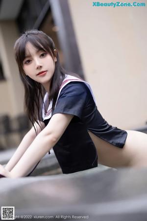 A woman in a school uniform posing for the camera.