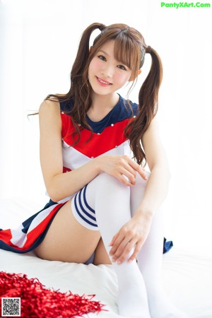A woman in a cheerleading uniform posing for the camera.