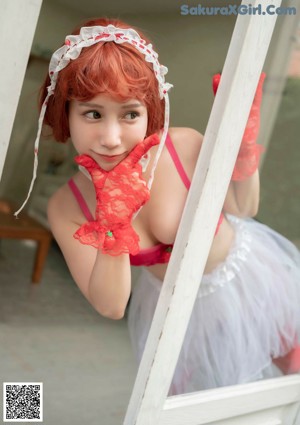 A woman in a red and white dress and red gloves.