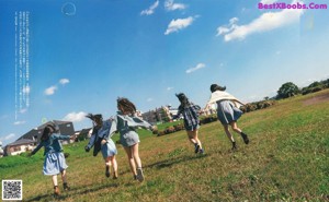 A group of young women standing next to each other on a dirt road.