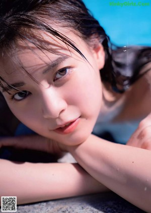 A woman in a black bikini posing for a picture.