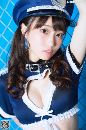A woman in a police uniform holding a pair of handcuffs.