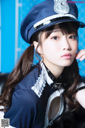 A woman dressed as a police officer posing for a picture.